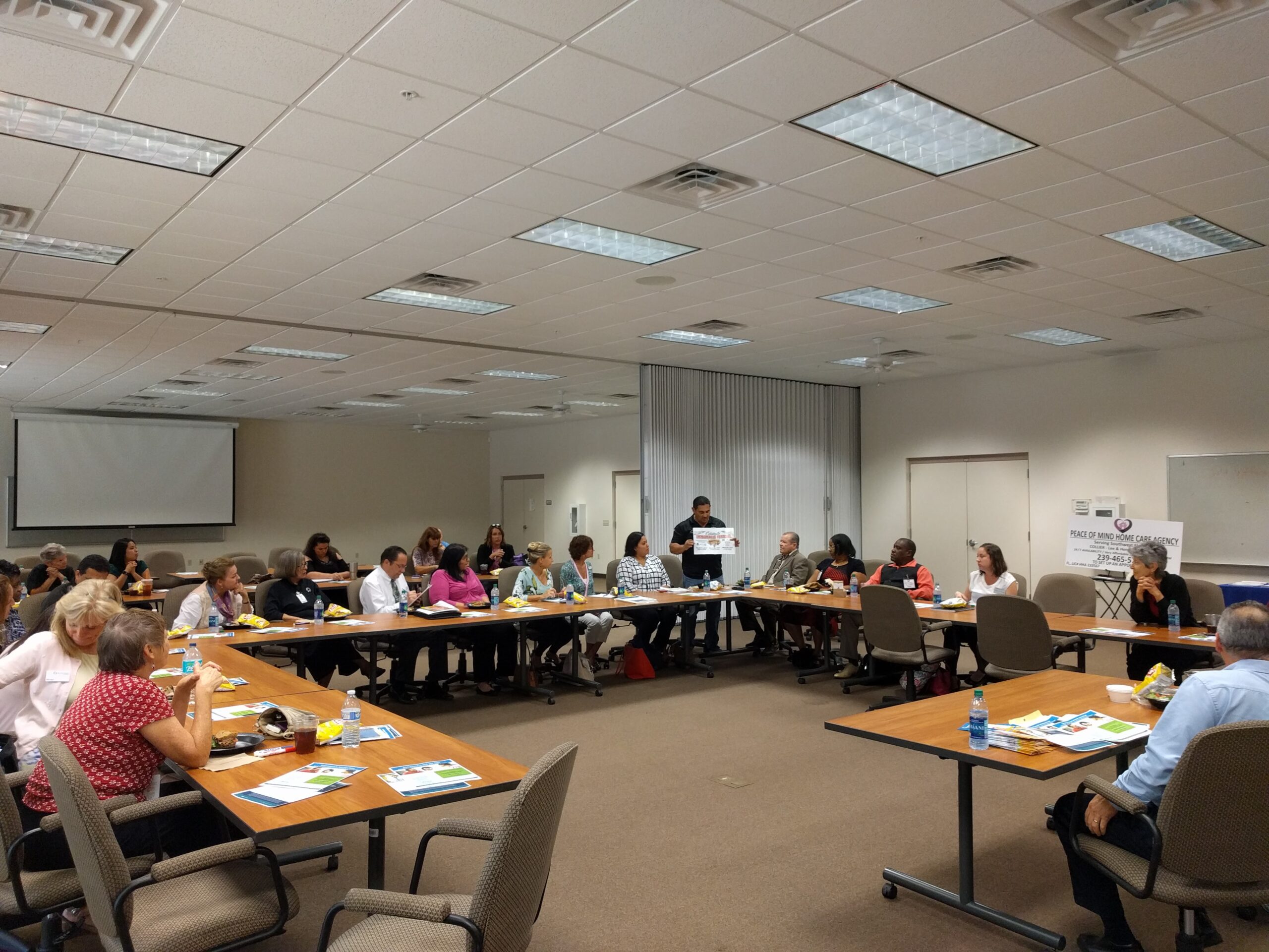 Wide view of IIAC members seated around tables