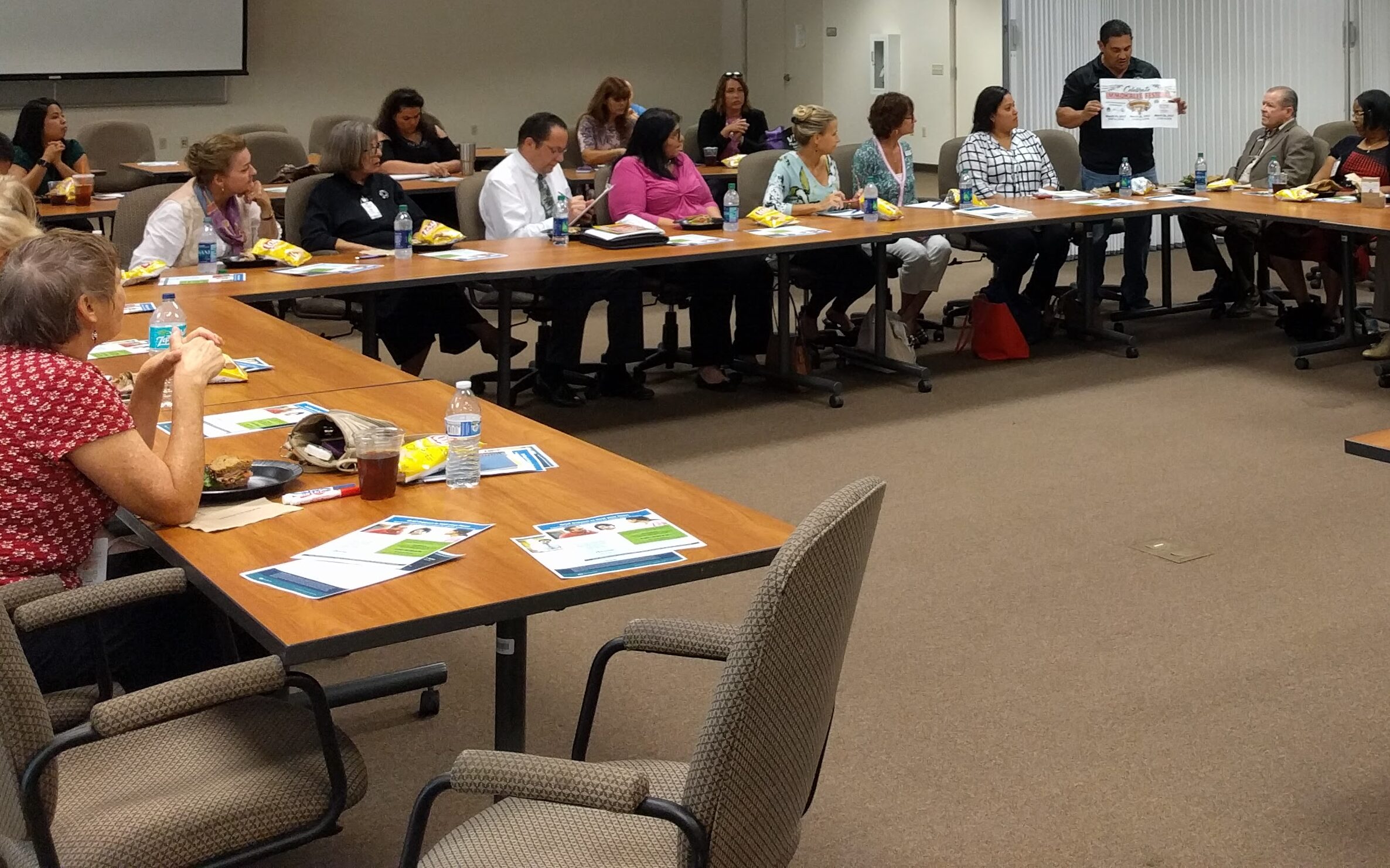 IIAC members reviewing materials at a monthly meeting